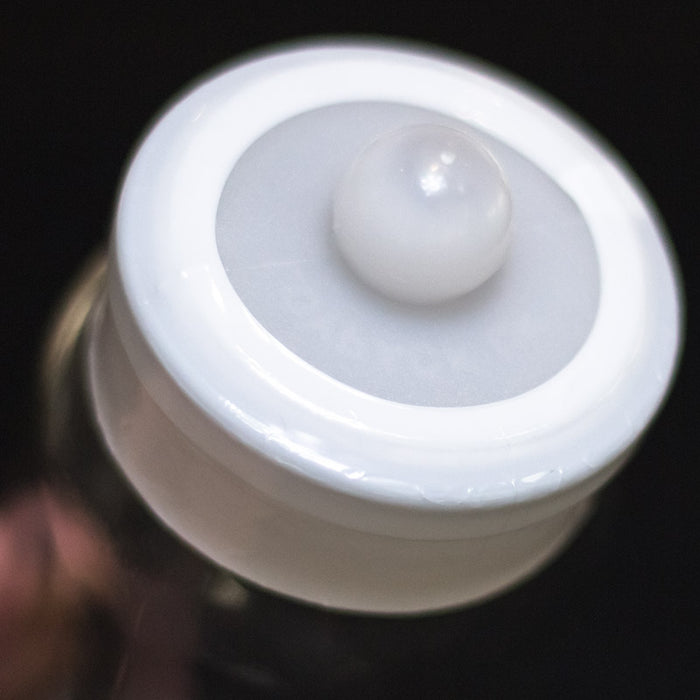 Tamper evident seals showing adhesive backing detail on a white background