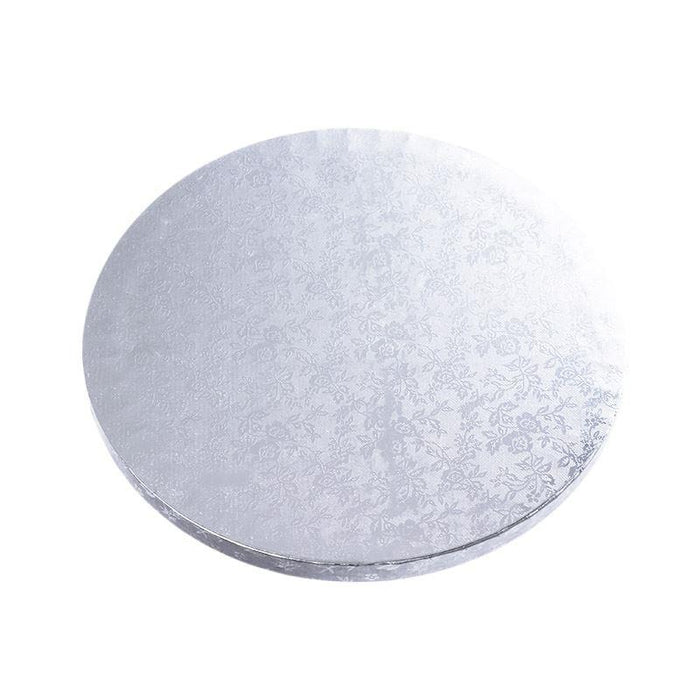 Round cake board with textured surface on a white background