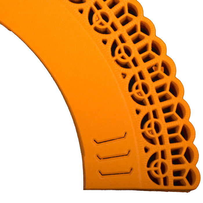 Close-up of an orange adjustable cupcake wrappers on a white background