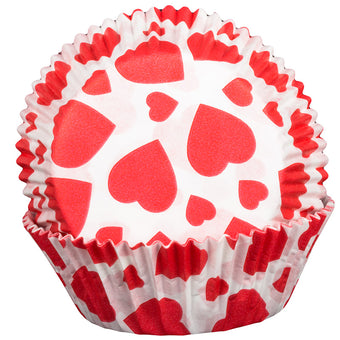 Red heart-patterned cupcake liner on a white background