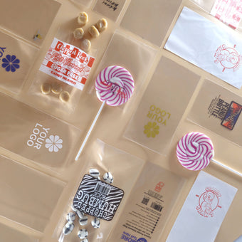 Assortment of personalised printed packaging bags made by Yolli showing design variety
