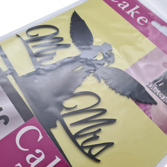 Cake topper in packaging with 'Mr' and 'Mrs' on a colorful background