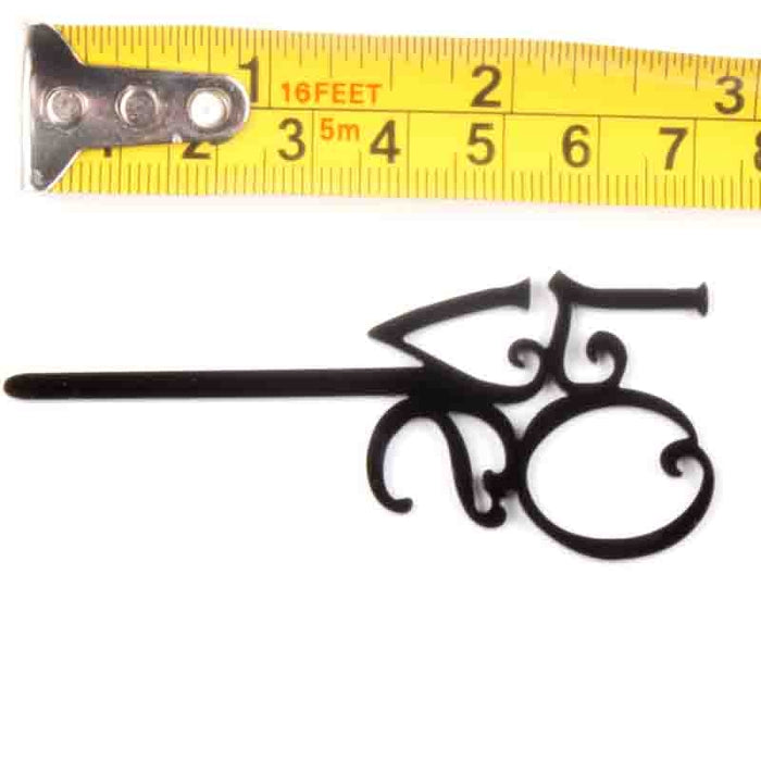 Decorative cake topper with a measuring tape showing its length on a white background