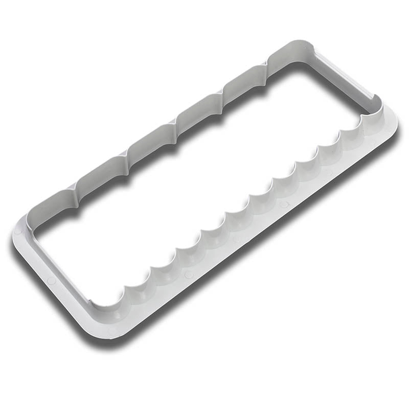 White plastic wavy and ribbed edge cutter on a white background