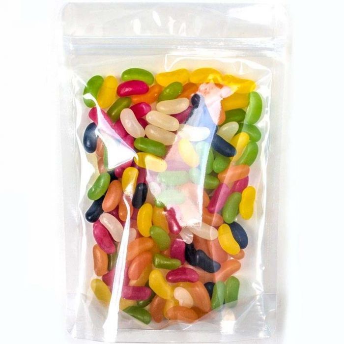 Clear plastic bag filled with colorful jelly beans on a white background
