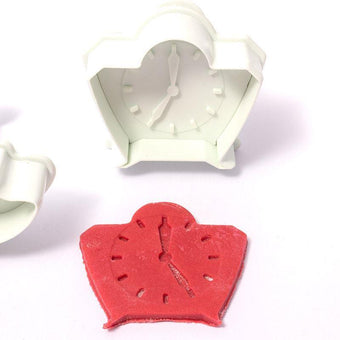 White clock-shaped  fondant plunger cutter on a white background