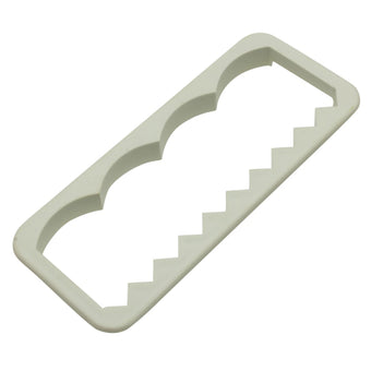 White plastic fondant edging cutter on a white background