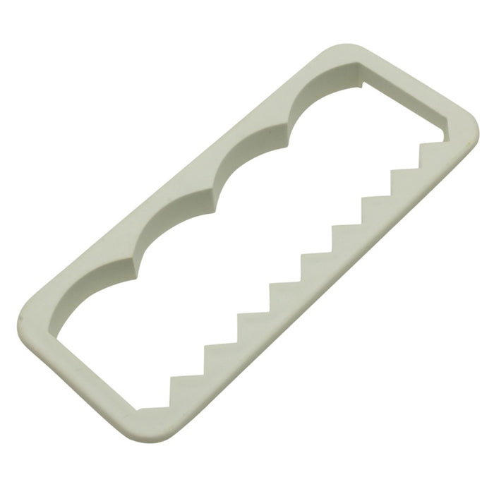 White plastic fondant edging cutter on a white background