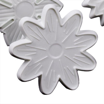 White flower-shaped fondant veiner on a white background