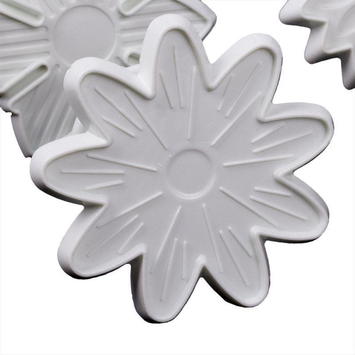 White flower-shaped fondant veiner on a white background