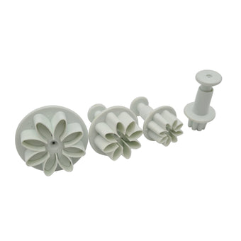Set of white floral plunger cutters on a white background