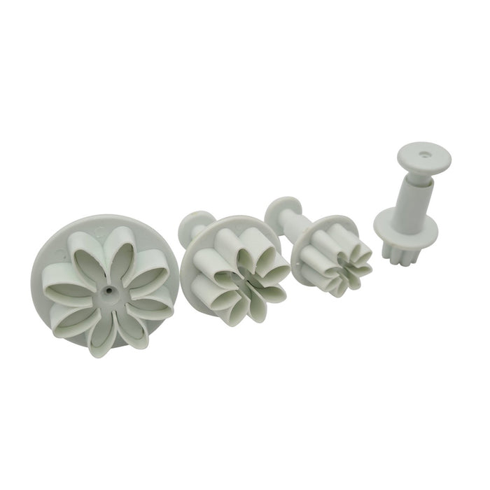 Set of white floral plunger cutters on a white background