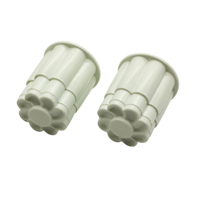 Two white cookie cutter moulds on a white background