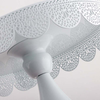 White cake stands on a white background