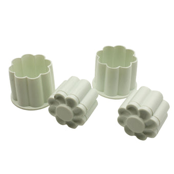 Set of white plastic cookie cutter molds on a white background