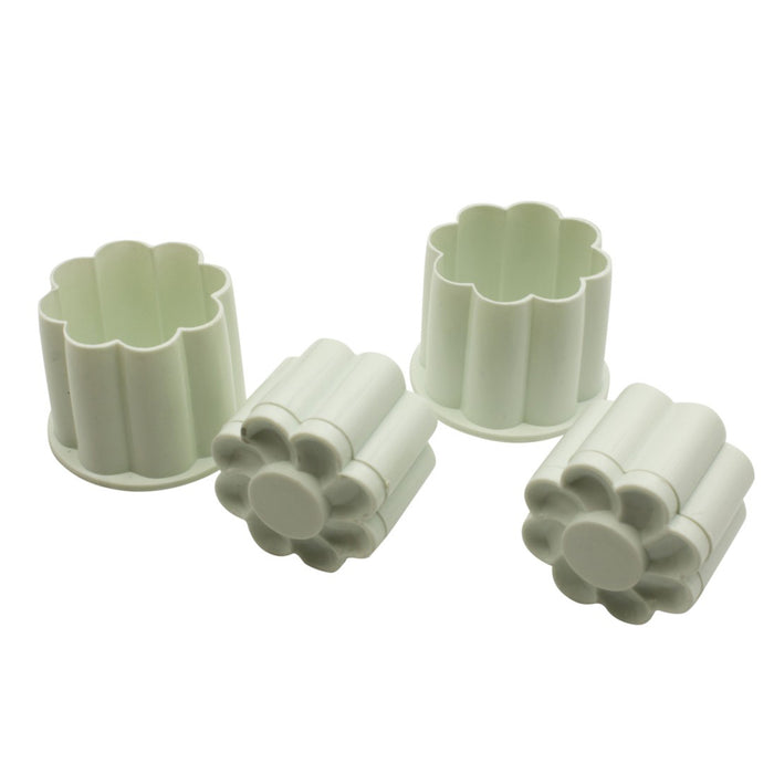 Set of white plastic cookie cutter molds on a white background