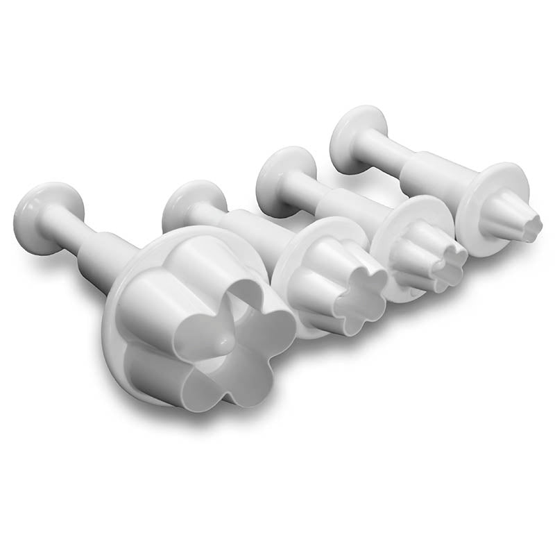 Set of white plastic flower-shaped plunger tools on a white background