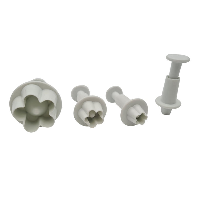 Set of four white plastic fondant plunger cutters on a white background