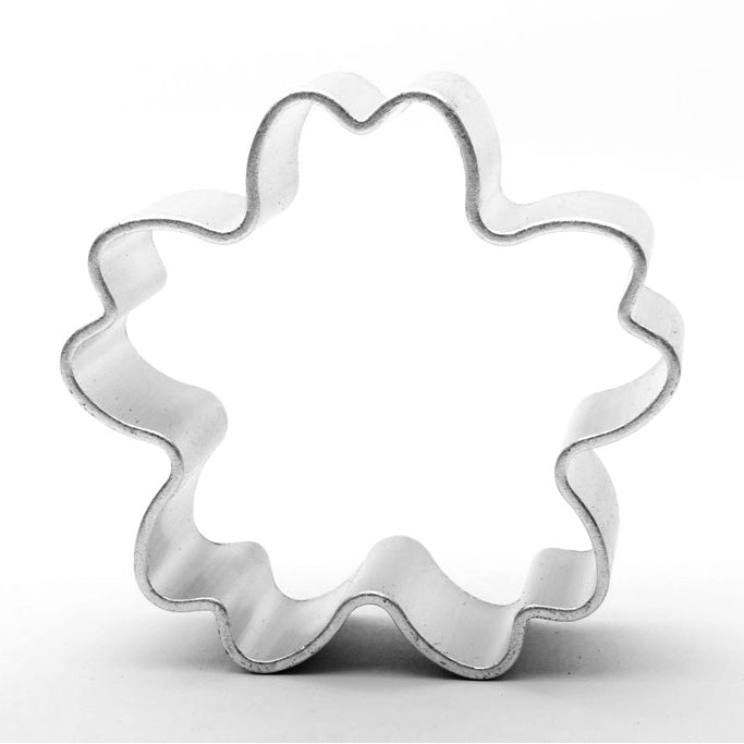 Flower-shaped cookie cutter on a white background