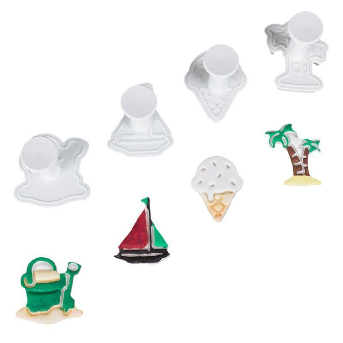 Set of various plunger cutters including a palm tree, ice cream cone, sailboat, bucket and spade on a white background.