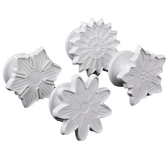 Set of four white floral-shaped fondant veiner on a white background