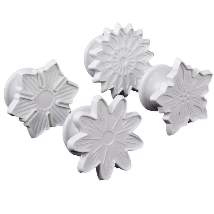 Set of four white floral-shaped fondant veiner on a white background
