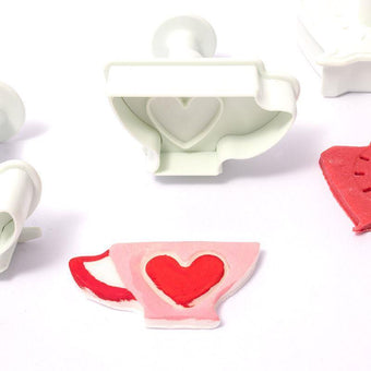 Plunger cutters shaped like a teapot and a heart on a white background