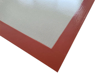 Silicone baking mat with red border on a white background