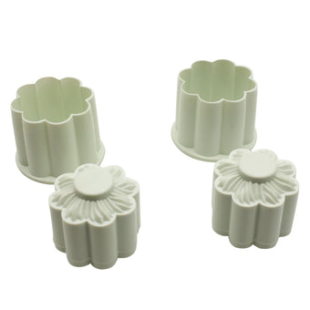 Set of two white floral-shaped cookie cutters on a white background