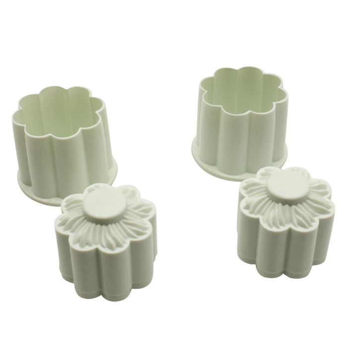Set of two white floral-shaped cookie cutters on a white background