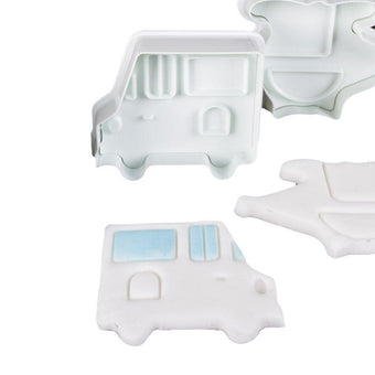 White fondant plunger cutters shaped like a van on a white background
