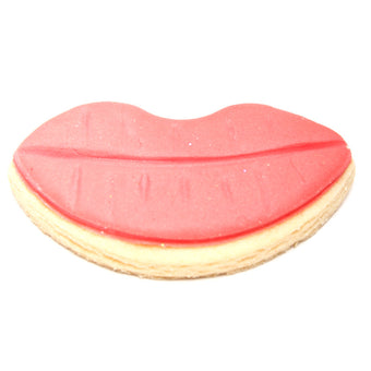Cookie shaped like lips with red top and beige bottom on a white background