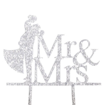 Cake topper with 'Mr & Mrs' text and silhouette of a couple on a white background