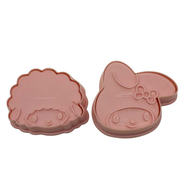Two pink cookie cutters shaped like cartoon characters on a white background