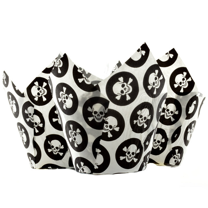 Three paper cupcake cases with skull and crossbones design on a white background