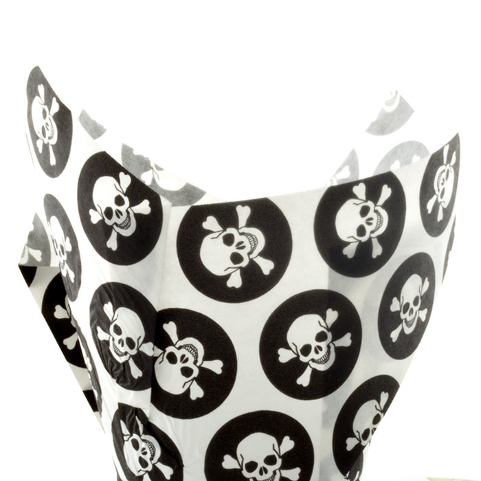 White and black paper cupcake cases with black skull and crossbones pattern on a white background