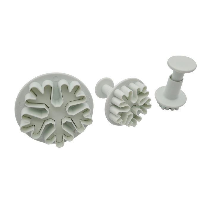 Set of 3 snowflake shaped fondant plunger cutters on a white background