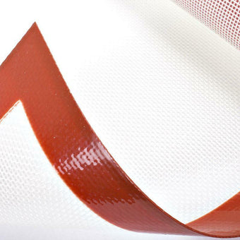 Close-up of a red bordered silicone baking mat on a white background
