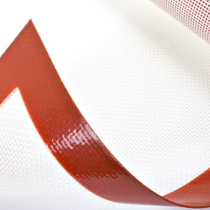 Close-up of a red bordered silicone baking mat on a white background