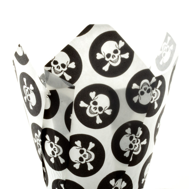 White cupcake liner with black skull and crossbones pattern