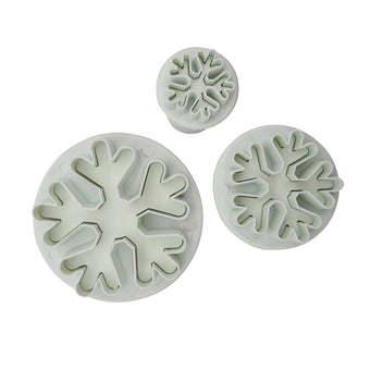 Set of 3 snowflake shaped fondant plunger cutters on a white background
