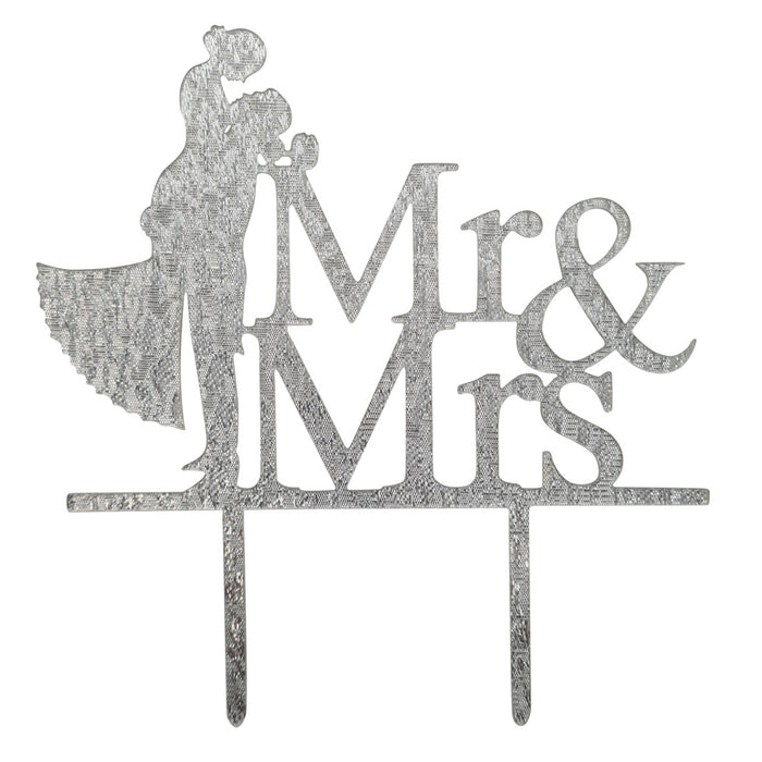 Decorative cake topper with 'Mr & Mrs' text and silhouettes of a couple on a white background.