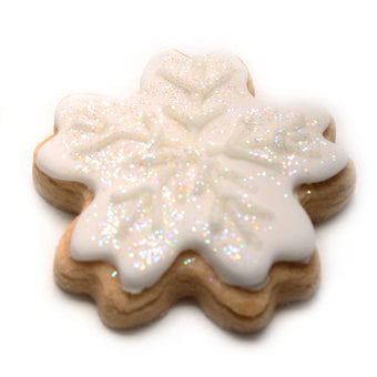Snowflake-shaped cookie with white icing and glitter on a white background