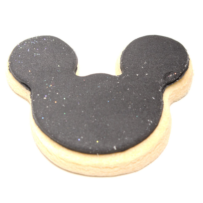 Cookie shaped like a Mickey Mouse head with black and beige colors on a white background