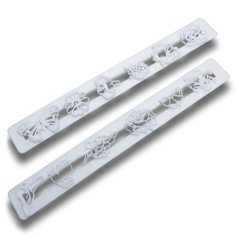 Two white frill cutters on a white background