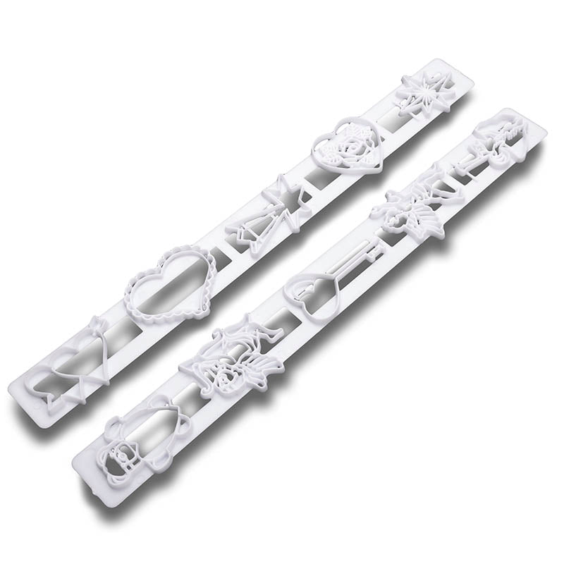 Two white plastic frill cutters with hearts and cherubs on a white background