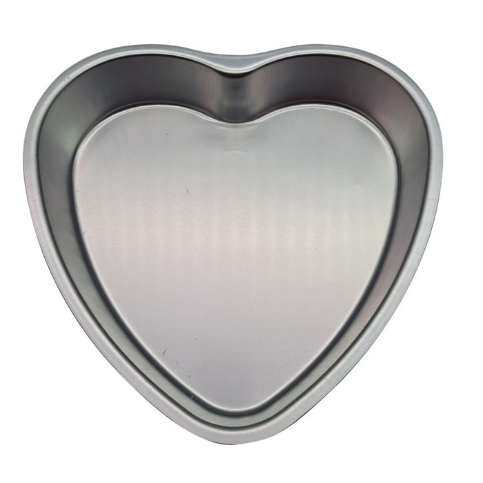 Heart-shaped metal cake pan on a white background