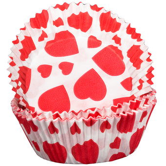 Red heart patterned cupcake liners on a white background