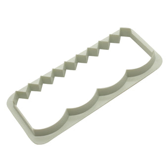 White plastic fondant edging cutter on a white background