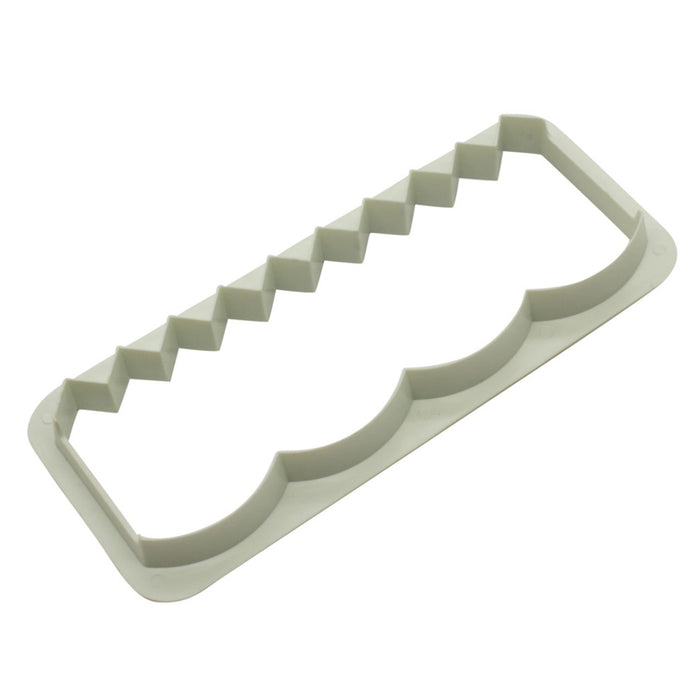 White plastic fondant edging cutter on a white background
